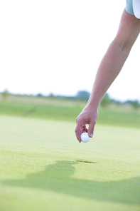 Cropped image of hand holding golf ball