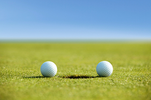 Golf balls near hole