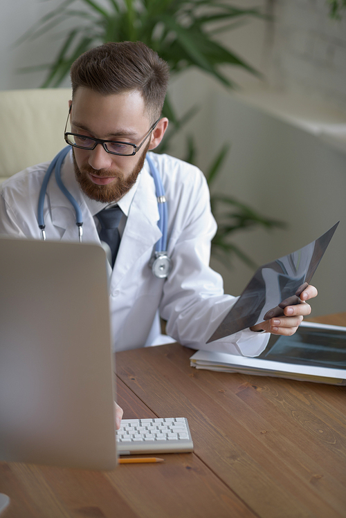 Doctor examining an elbow x-ray. Medicine and healthcare