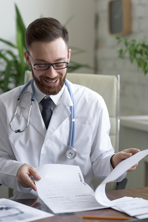 Doctor working with test results of his patient at his office