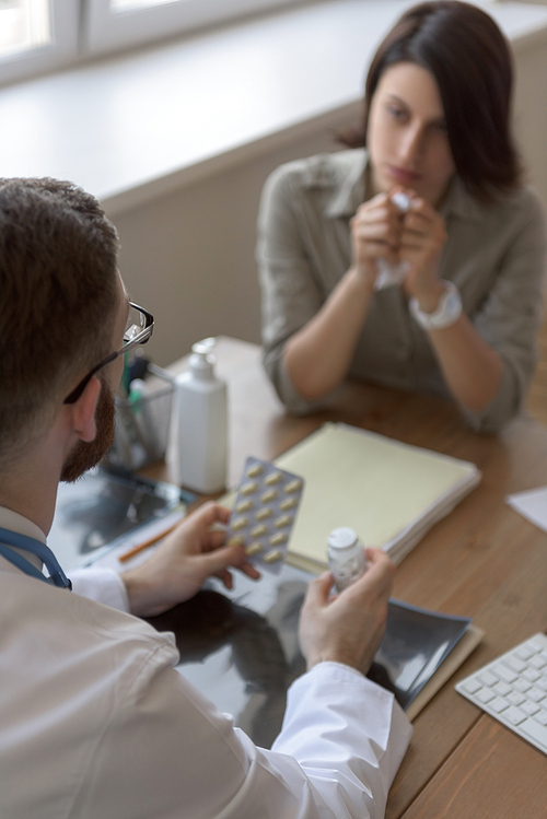 At doctor office. Doctor prescribing medication to patient