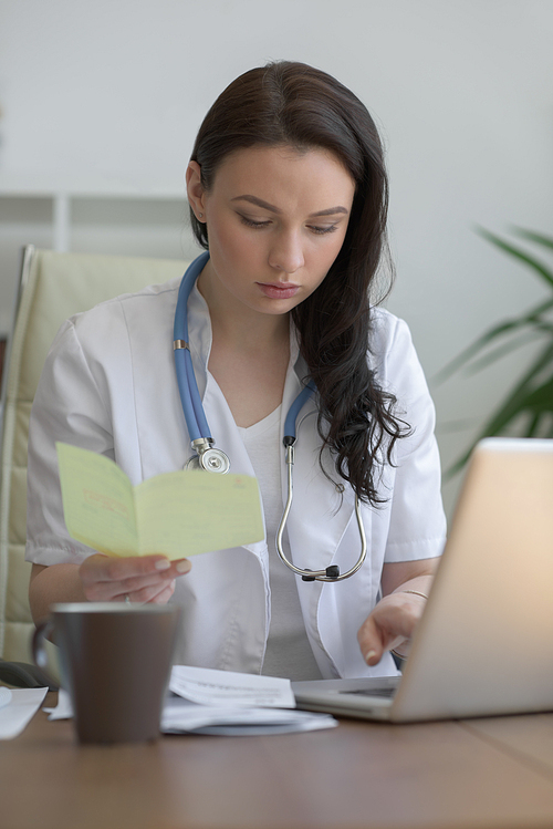 Doctor analyzing medical test results of her patient at her office