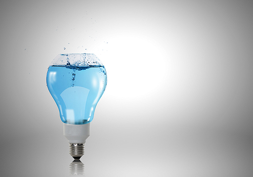 Conceptual image with light bulb filled with clear water