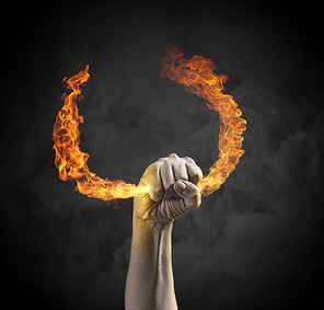 Close up of human hand holding fire flame