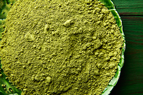 Matcha tea powder for japanese ceremony on green plate table