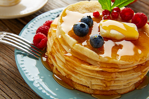 pancakes breakfast syrup coffee and orange juice with berries