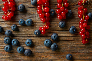 Berries mix on wooden board blueberries and red currants