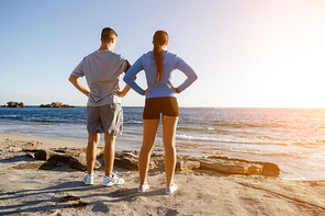 Young couple on beach training and exercising together