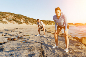 Young couple on beach training and exercising together