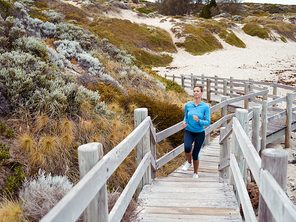 Sporty young woman running up the stairs