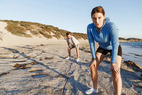 Young couple on beach training and exercising together