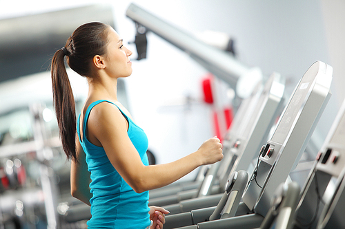 Image of fitness girl running on treadmill