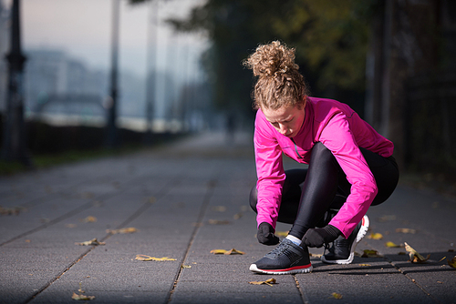 runner   woman warming up and stretching before morning jogging