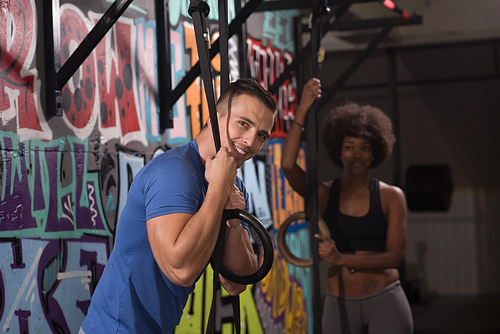 dip ring young man and african american woman relaxed after workout at gym dipping exercise