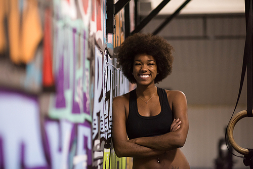 Fitness dip ring african american young woman relaxed after workout at gym dipping exercise