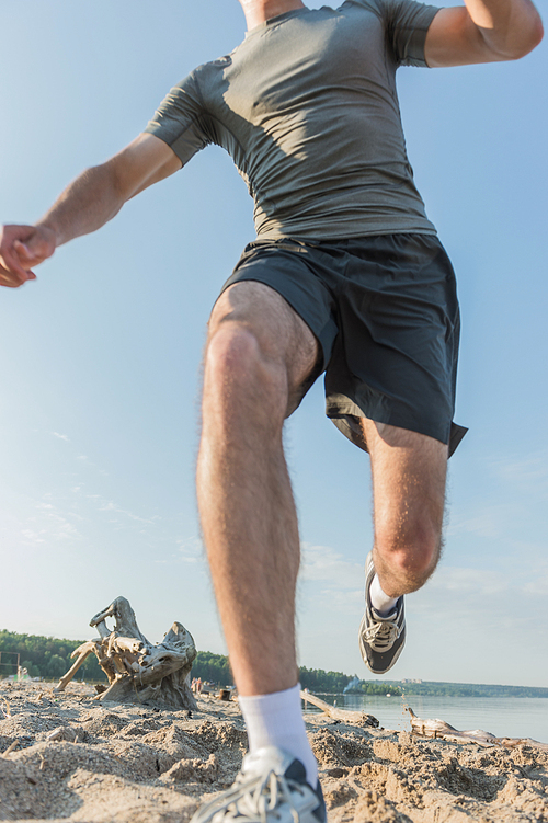 Runner athlete running at seaside. Man fitness morning jogging workout wellness concept