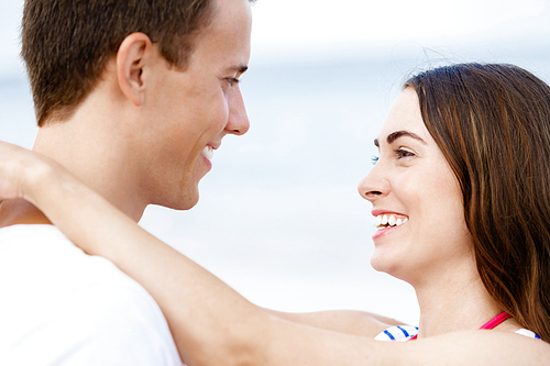 Portraits of romantic young couple on the beach
