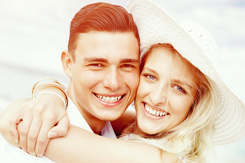 Portraits of romantic young couple on the beach