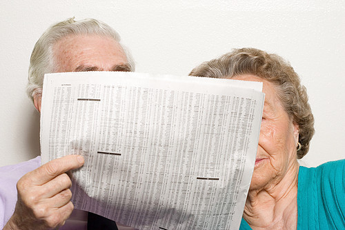 Elderly couple with newspaper
