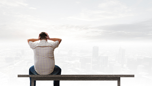 Fat man sitting on bench closing eyes with hands