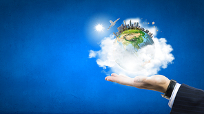 Close up of male hand holding our Earth planet. Elements of this image are furnished by NASA