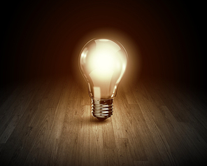 Background image with glowing light bulb on wooden surface