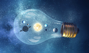 Planets of sun system inside of glass light bulb. Elements of this image are furnished by NASA