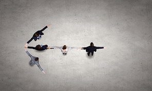 Business people with stretched arms making figure of arrow