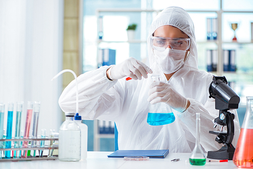 Chemist working in the laboratory with hazardous chemicals