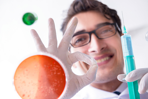 Chemist working in the laboratory with hazardous chemicals