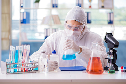 Chemist working in the laboratory with hazardous chemicals