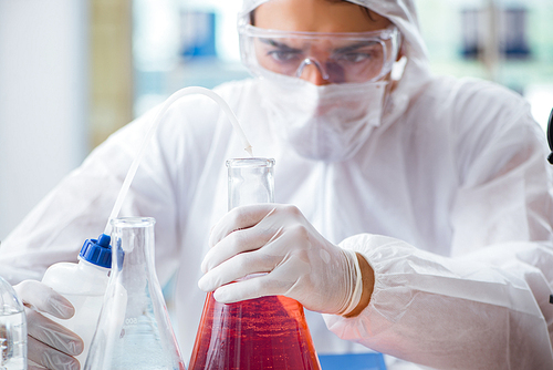 Chemist working in the laboratory with hazardous chemicals