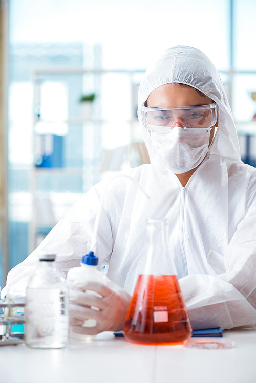 Chemist working in the laboratory with hazardous chemicals