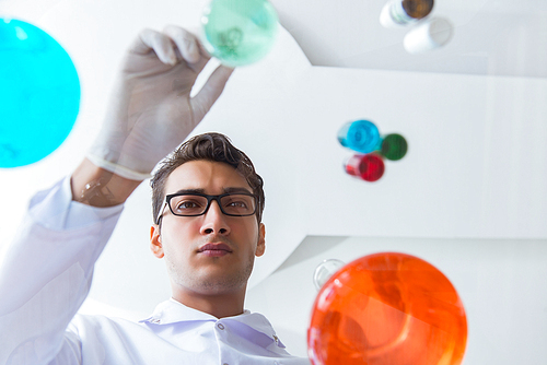 Chemist working in the laboratory with hazardous chemicals