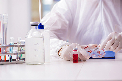 Chemist working in the laboratory with hazardous chemicals