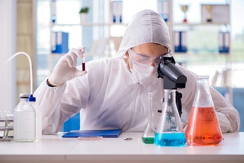 Chemist working in the laboratory with hazardous chemicals