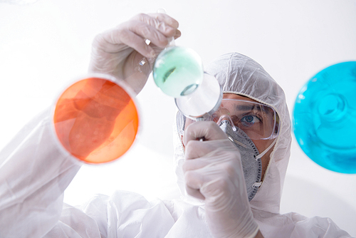 Chemist working in the laboratory with hazardous chemicals