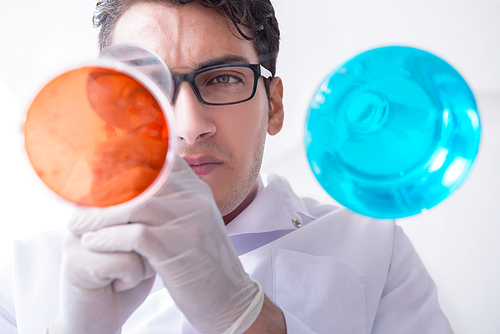 Chemist working in the laboratory with hazardous chemicals