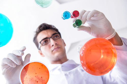 Chemist working in the laboratory with hazardous chemicals