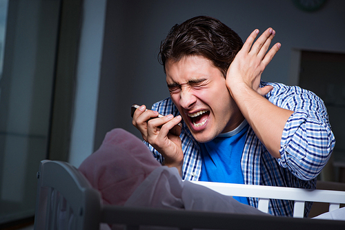 Young father under stress due to baby crying at night