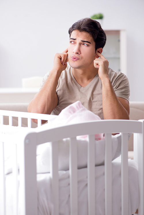 Young father dad frustrated at crying baby