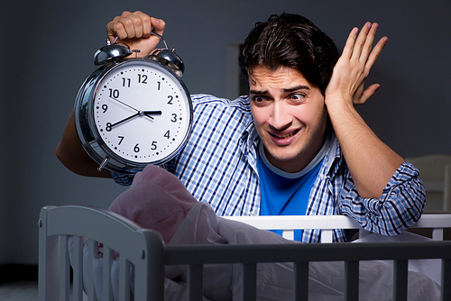 Young father under stress due to baby crying at night