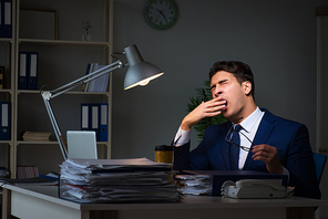 Businessman tired and sleeping in the office after overtime hours