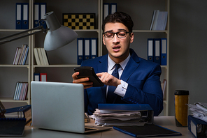 Auditor checking the accuracy of financial statements with calculator