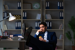 Businessman tired and sleeping in the office after overtime hours