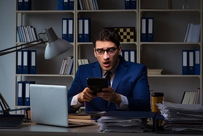 Auditor checking the accuracy of financial statements with calculator