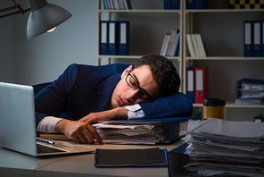 Businessman tired and sleeping in the office after overtime hours