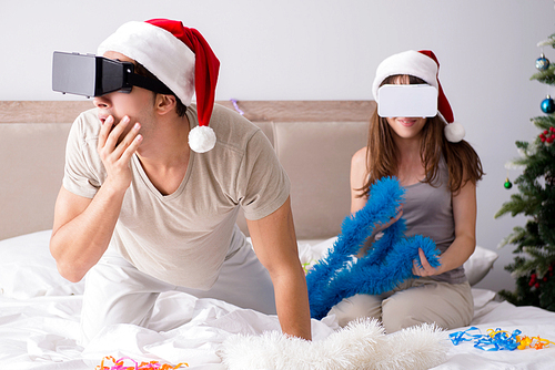 Happy couple celebrating christmas holiday in bed