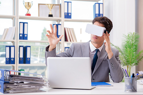 Businessman with VR virtual reality glasses in office