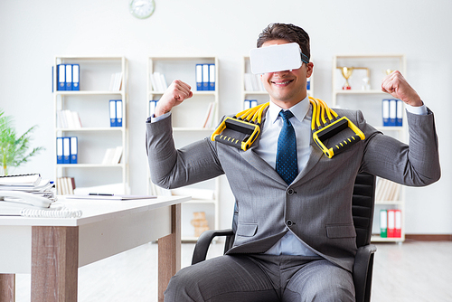 Businessman exercising with elastic expander wearing VR glasses